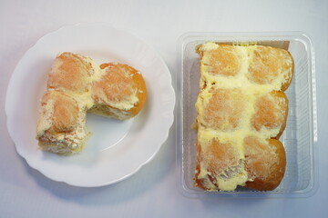 Bread rolls spread with butter and sugar