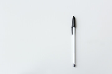 One black and white ballpoint pen isolated with copy space. Office supply, school stationery, authorship, letter writing concept. Simple and minimalist banner design. 