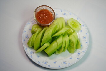 Chopped cucumber and shrimp paste in a small glass bowl.