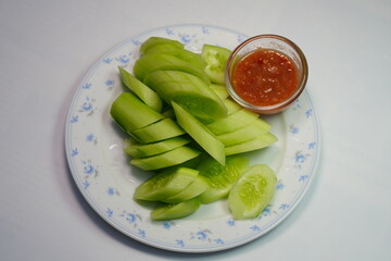 Chopped cucumber and shrimp paste in a small glass bowl.