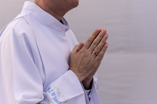 Seminarians make a prayer sign with their hands during a tribute to Our Lady of Conceicao da Praia. Salvador, Bahia.