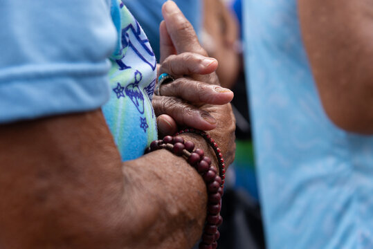 Detail of the hands of a Catholic believer during a tribute to Our Lady of Conceicao da Praia in the city of Salvador, Bahia.