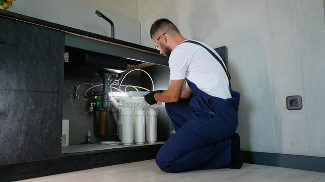 Plumber Installing Reverse Osmosis Water Filtration System