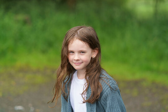 Smiling little cute girl walking on outdoor in summer. Concept of active healthy sporty child