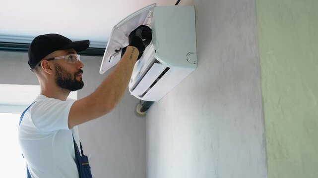 Technician Checking Air Conditioner Filter for Maintenance