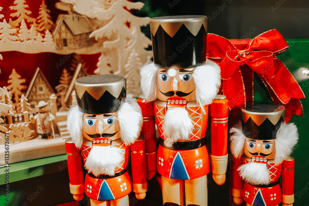 Sticker Red Nutcrackers wooden dolls set.Symbol of Christmas and New Year.Beautiful winter festive background in red tones.Christmas holiday symbol on a blurred background.Christmas toys and decorations. 