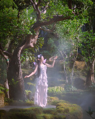 Portrait fantasy Angel Fairy Tale woman in forest natural trees. Elf girl fashion in pink dress with butterfly wings fairy tale story world. Walks in fresh green trees with magic radiance.