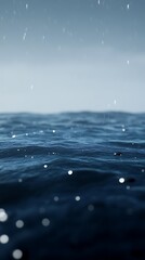 A serene ocean scene with gentle waves and raindrops creating a tranquil atmosphere.