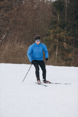 Solo cross-country skier in a winter forest during a training session