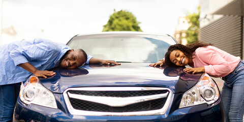 Happy Car Buyers, New Owners Concept. Portrait Of Excited Young African American Couple Touching...