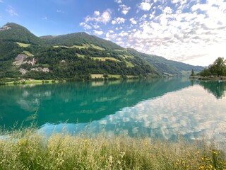 Naklejka premium Lake Lungern or Natural reservoir Lungerersee - Canton of Obwald, Switzerland (Naturstausee Lungernsee oder Lungerensee - Kanton Obwald, Schweiz)