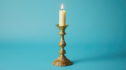 Vintage golden candlestick with a lit candle against a vibrant blue backdrop creating an elegant and nostalgic ambiance.