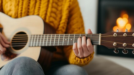 Obraz premium Playing acoustic guitar by the fireplace cozy indoor setting music and leisure activity home environment