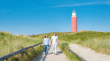 A couple leisurely walks along a scenic path near the Texel Lighthouse, enjoying the stunning...