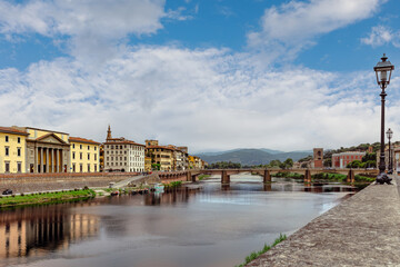 View of the Arno River and historic architecture in the heart of Florence on a clear day