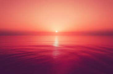 Obraz premium Sunset casts a warm glow over calm ocean waters creating a serene atmosphere during twilight hours. Gentle waves ripple across the ocean as the sun sets on the horizon.