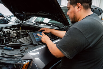 Young Latino Man Performing a Car Check-Up with the Hood Open