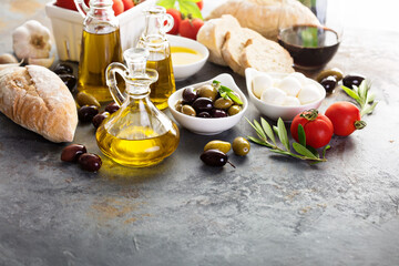 Olive oil in vintage bottles and italian cuisine ingredients