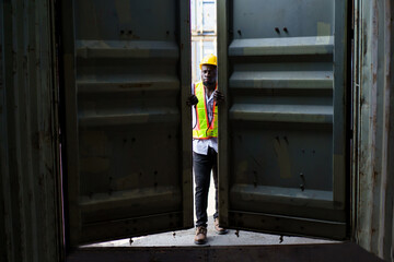 Engineer inspects a containers in container yard.