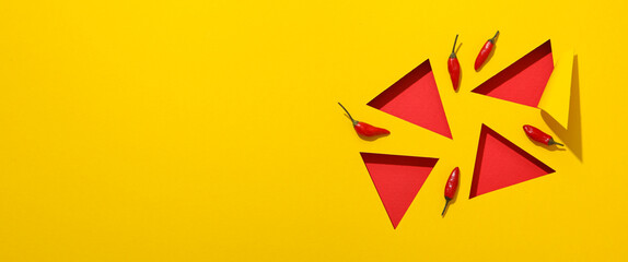 Chili pepper with red triangles on a yellow background