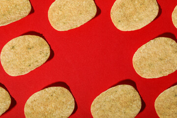 Crispy potato chips on a red background