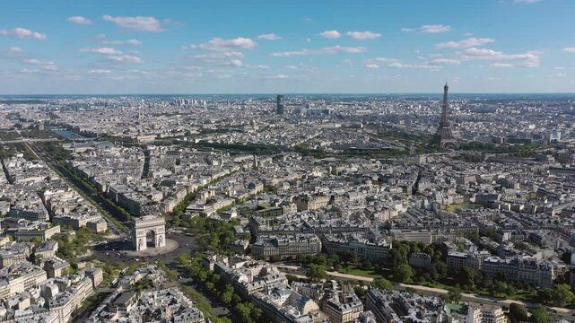 PARIS, FRANCE - OCTOBER 3, 2024: Stunning aerial view of Paris showcasing the Arc de Triomphe and Eiffel Tower under a clear sky