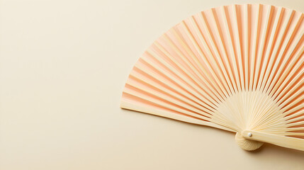 Peach hand fan on beige background.