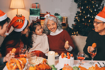 Happy multigeneration family enjoying in opening gifts on Christmas eve at home.