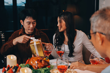 Merry Christmas! Happy family are having dinner at home. Celebration holiday and togetherness near tree.