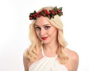 close up portrait of beautiful blonde female model wearing holly and ivy Christmas  fantasy wreath...