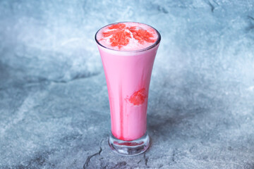 Strawberry Milkshake served in glass isolated on grey background side view of Indian and Bangladeshi drink