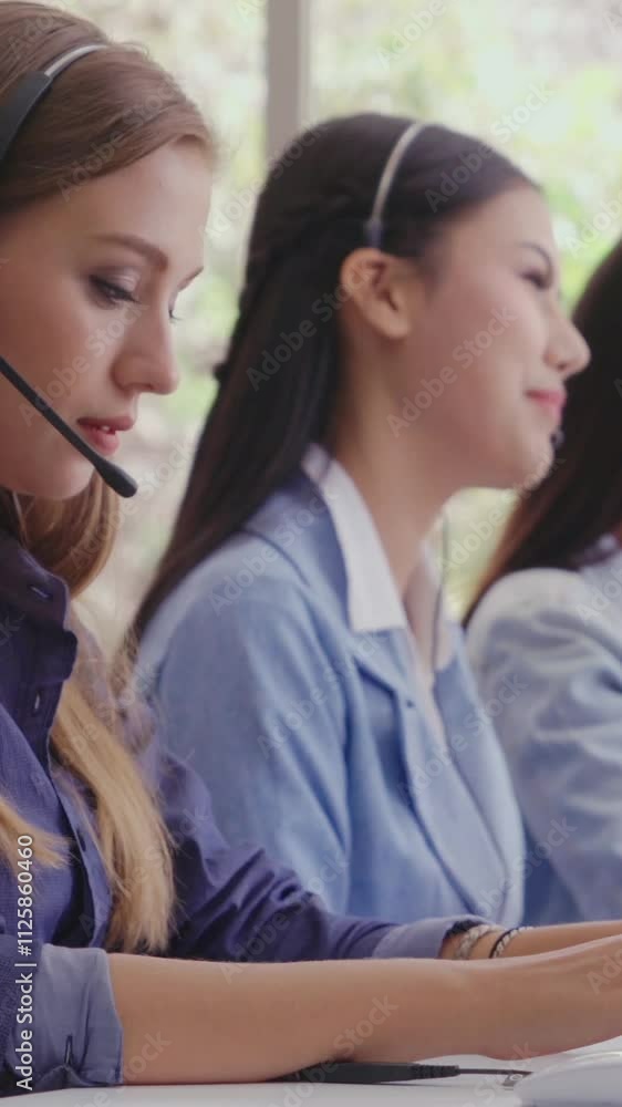 Poster customer support agent or call center with headset works on desktop computer while supporting the cu