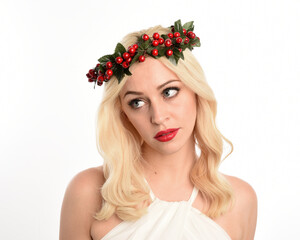 close up portrait of beautiful blonde female model wearing holly and ivy Christmas  fantasy wreath...