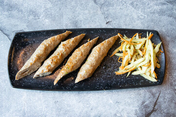 Chicken Seekh kebab with cucumber, carrot salad served in tray dish isolated on grey background side view of Indian and Bangladeshi food