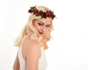 close up portrait of beautiful blonde female model wearing holly and ivy Christmas  fantasy wreath...