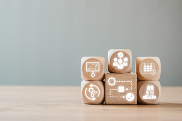 Wooden blocks with icons symbolizing workflow, teamwork, and productivity, ideal for illustrating...