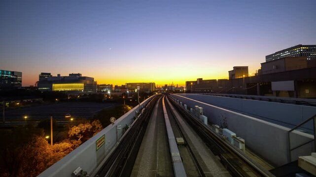 POV Time-lapse from front of Automated subway Yurikamome line in Tokyo Japan during twilight circa 2024.