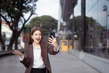 Asian businesswoman chatting in the city center