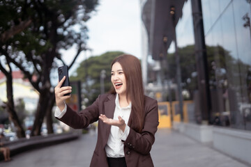 Asian businesswoman chatting in the city center