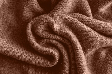 Mocha Mousse Background. Top view of soft warm textile texture with swirl of waves. Trendy color of year 2025 - Mocha Mousse. Abstract Background Textile