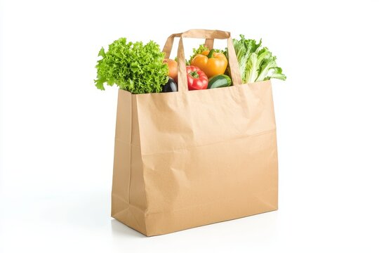 Fresh produce in a brown paper grocery bag on white background.