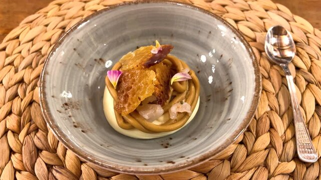 Close-up of fine dining dish prepared by a chef. А dessert of lychee and lavender, caramelized white chocolate, and miso. Gourmet cuisine.