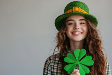 Smiling Woman Holding a Shamrock for St. Patrick's Day