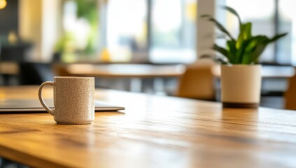 Coffee mug on wooden table in modern office.