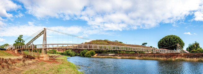 The historic Hanapepe Swinging Bridge, located on Kauai, Hawaii, was built in 1911. The pedestrian suspension bridge connected the town of Hanapepe with agricultural fields in the Hanapepe Valley.