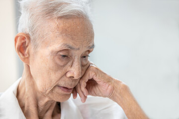 Closeup,asian senior elderly suffering cognitive and physical decline,health deterioration,memory loss,sadness in illness,concept of treatment,therapy,health care,medical,Dementia,Alzheimer's disease