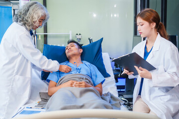 Two female doctors examine a patient lying on a hospital bed,discuss the medical chart,administer medicine,and provide encouragement, ensuring compassionate care and fostering the patient's recovery