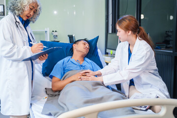 Two female doctors examine a patient lying on a hospital bed,discuss the medical chart,administer medicine,and provide encouragement, ensuring compassionate care and fostering the patient's recovery