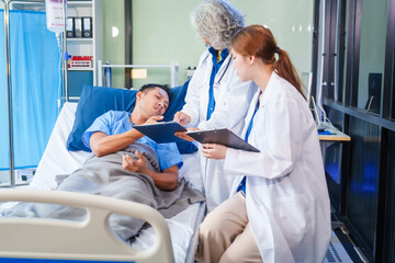 Two female doctors examine a patient lying on a hospital bed,discuss the medical chart,administer medicine,and provide encouragement, ensuring compassionate care and fostering the patient's recovery