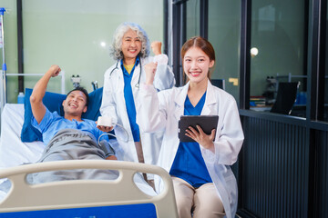 Fototapeta premium Two female doctors examine a patient lying on a hospital bed,discuss the medical chart,administer medicine,and provide encouragement, ensuring compassionate care and fostering the patient's recovery